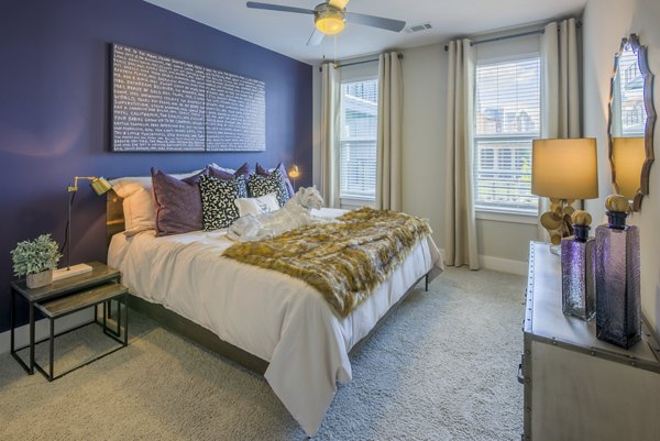 Luxurious bedroom with contemporary decor at Cadence Music Factory Apartments, offering a stylish retreat in urban Charlotte