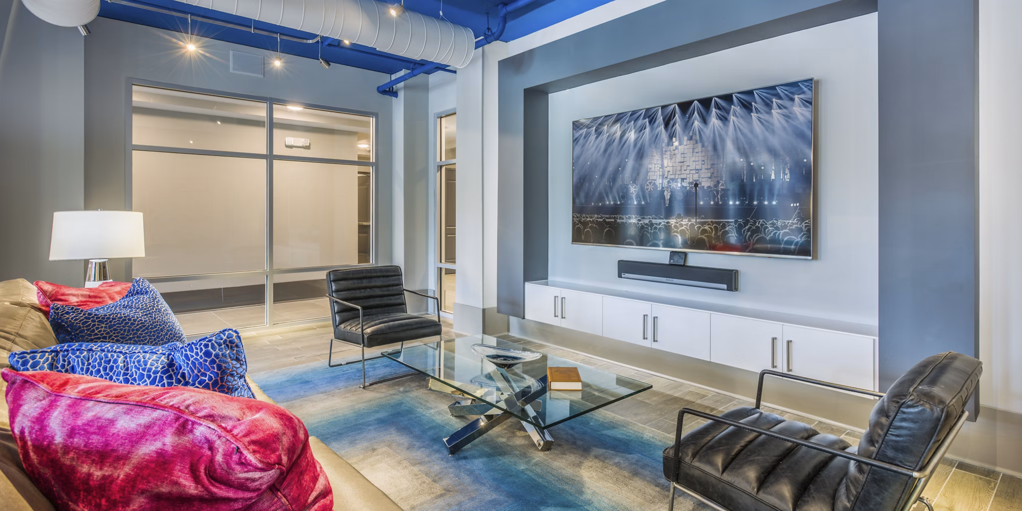 Clubhouse featuring modern decor and lounge seating at Cadence Music Factory Apartments