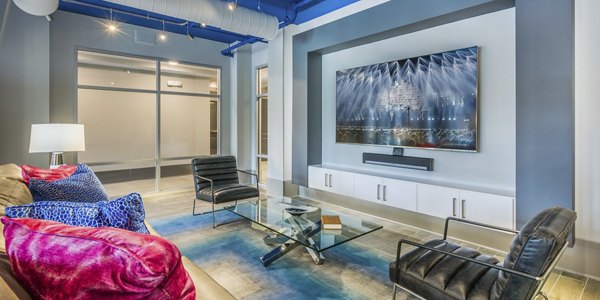Clubhouse featuring modern decor and lounge seating at Cadence Music Factory Apartments
