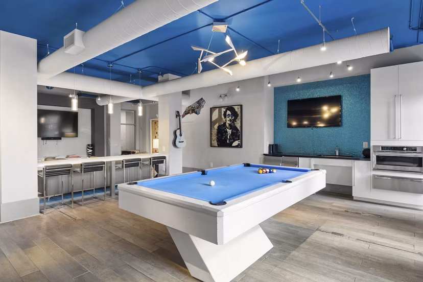 Cadence Music Factory: Modern clubhouse with lounge seating and entertainment options at luxury apartments in vibrant downtown location
