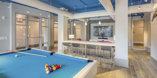 Clubhouse with modern decor at Cadence Music Factory Apartments, ideal for social gatherings and relaxation