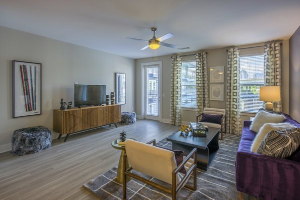 Spacious living room with modern decor in Cadence Music Factory Apartments