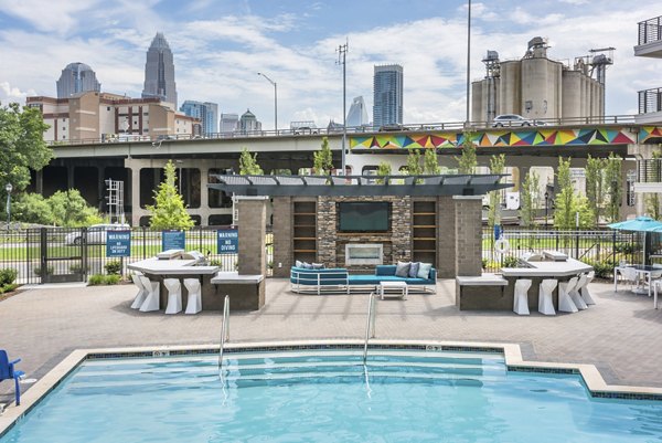 Resort-style pool with cabanas at Cadence Music Factory Apartments