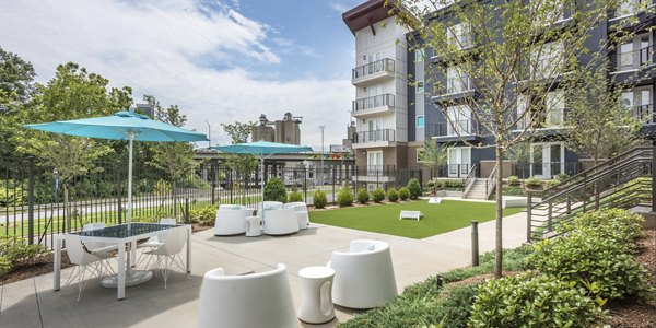 Modern courtyard with lush greenery at Cadence Music Factory Apartments, a luxury living experience
