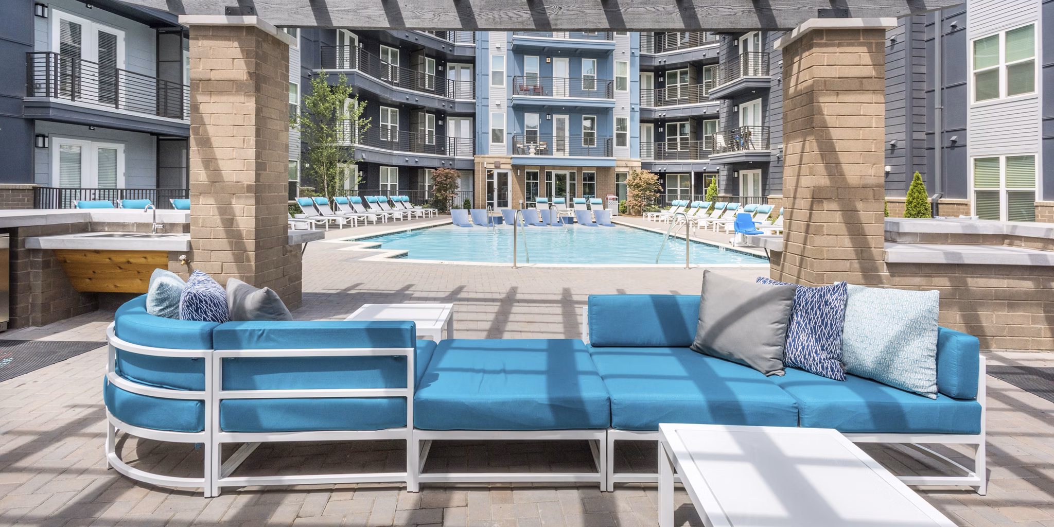 Stylish patio with modern furniture at Cadence Music Factory Apartments, offering relaxing outdoor living spaces in a luxury setting