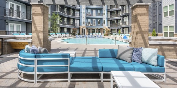 Stylish patio with modern furniture at Cadence Music Factory Apartments, offering relaxing outdoor living spaces in a luxury setting