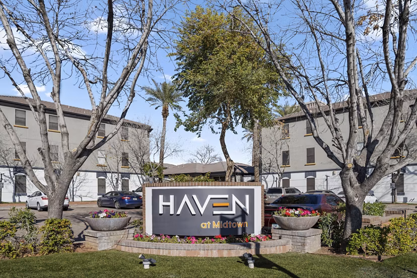 Haven at Midtown Apartments signage with modern typography and branding in vibrant city setting