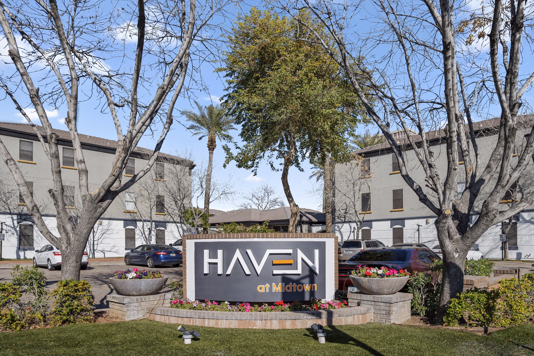 Haven at Midtown Apartments signage with modern typography and branding in vibrant city setting