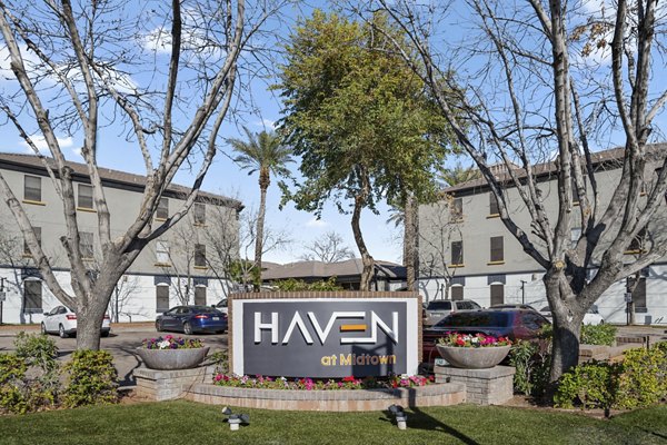 Haven at Midtown Apartments signage with modern typography and branding in vibrant city setting