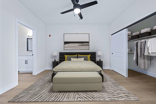 Modern bedroom with elegant furniture and large windows in Haven at Midtown Apartments