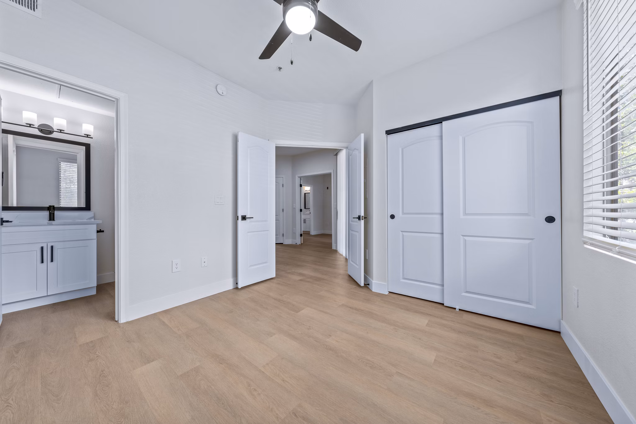 Bedroom featuring modern decor and large window in Haven at Midtown Apartments