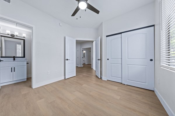 Bedroom featuring modern decor and large window in Haven at Midtown Apartments