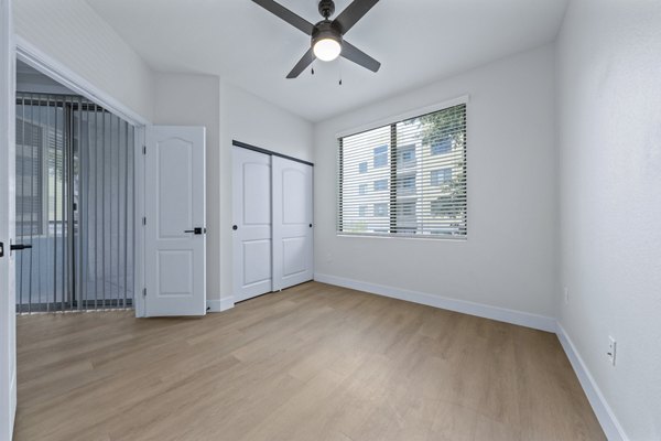 Bedroom with modern decor and large windows at Haven at Midtown Apartments, luxury living by Greystar in a vibrant urban setting
