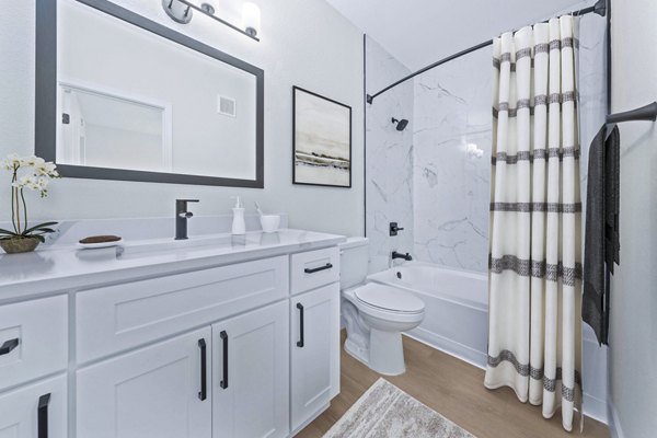 Elegant bathroom with marble countertops and glass shower at Haven at Midtown Apartments