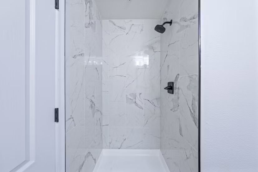 Sophisticated bathroom with sleek fixtures and marble accents at Haven at Midtown Apartments
