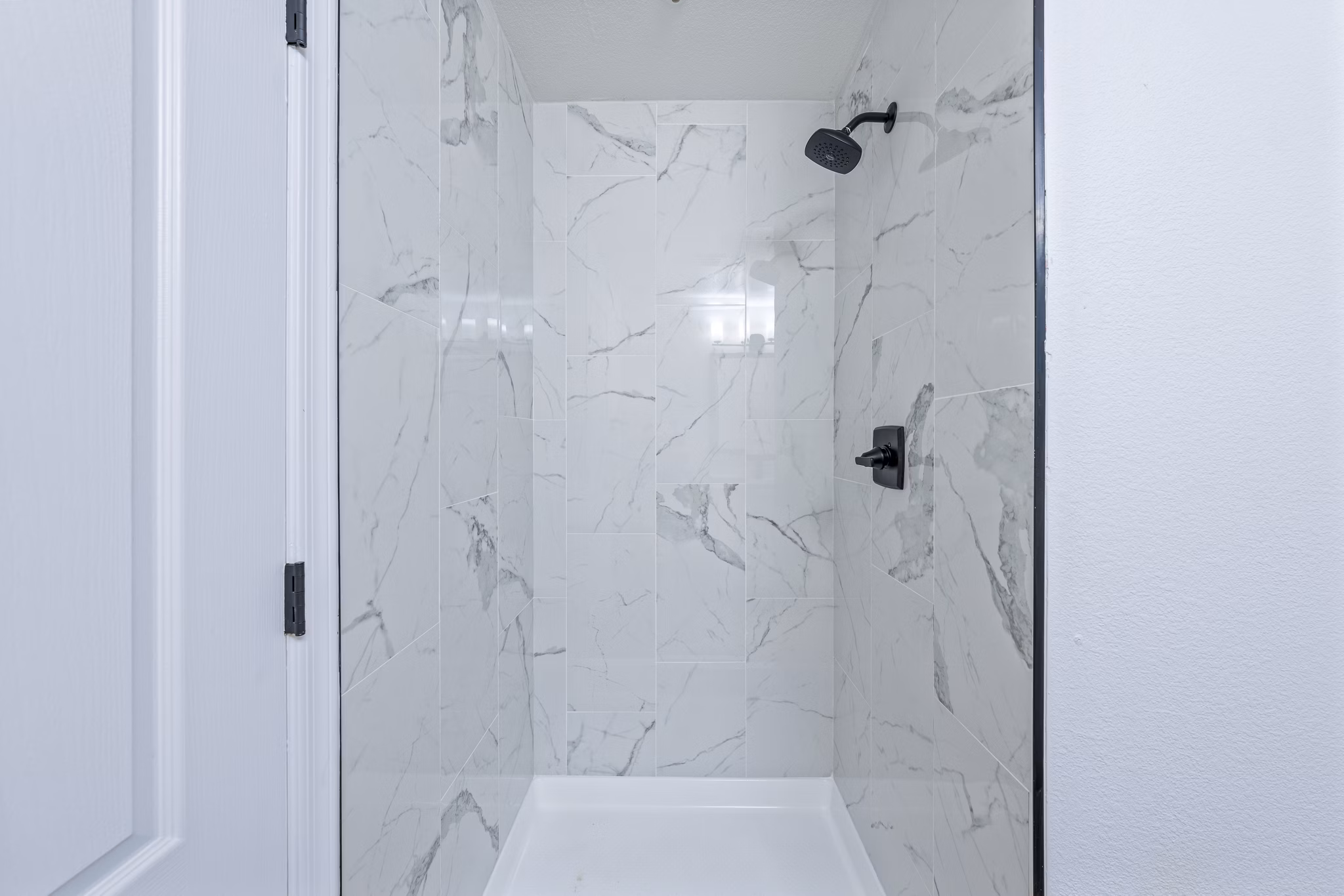 Sophisticated bathroom with sleek fixtures and marble accents at Haven at Midtown Apartments