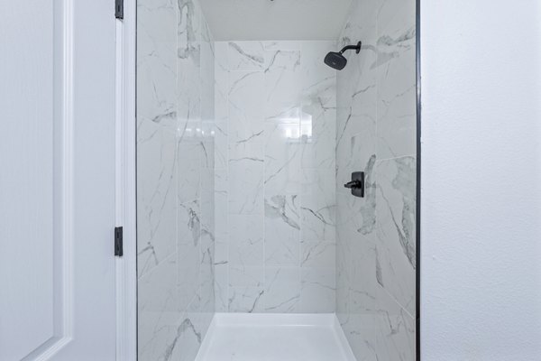 Sophisticated bathroom with sleek fixtures and marble accents at Haven at Midtown Apartments