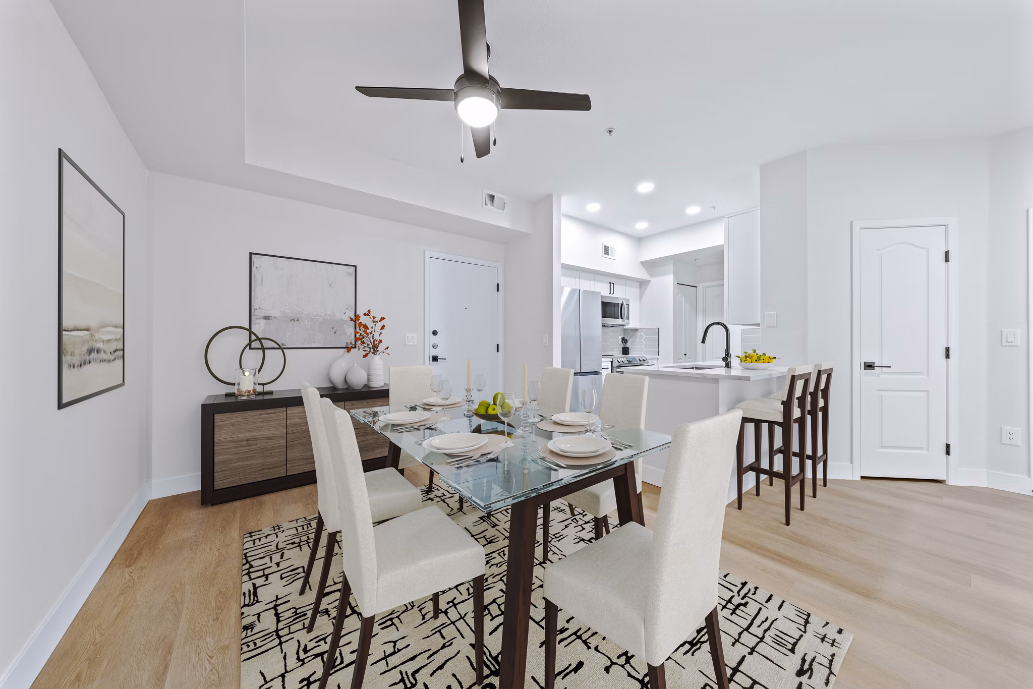 Elegant dining room with modern lighting and a stylish table setting at Haven at Midtown Apartments