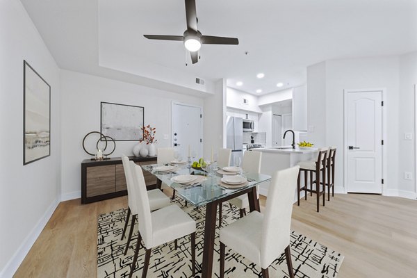 Elegant dining room with modern lighting and a stylish table setting at Haven at Midtown Apartments