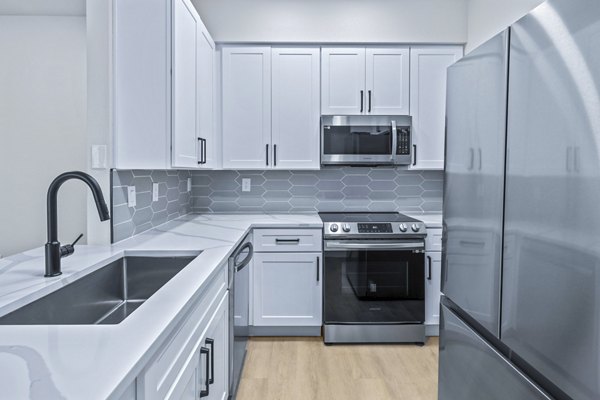 Haven at Midtown: Modern kitchen with stainless steel appliances and granite countertops in luxury apartments