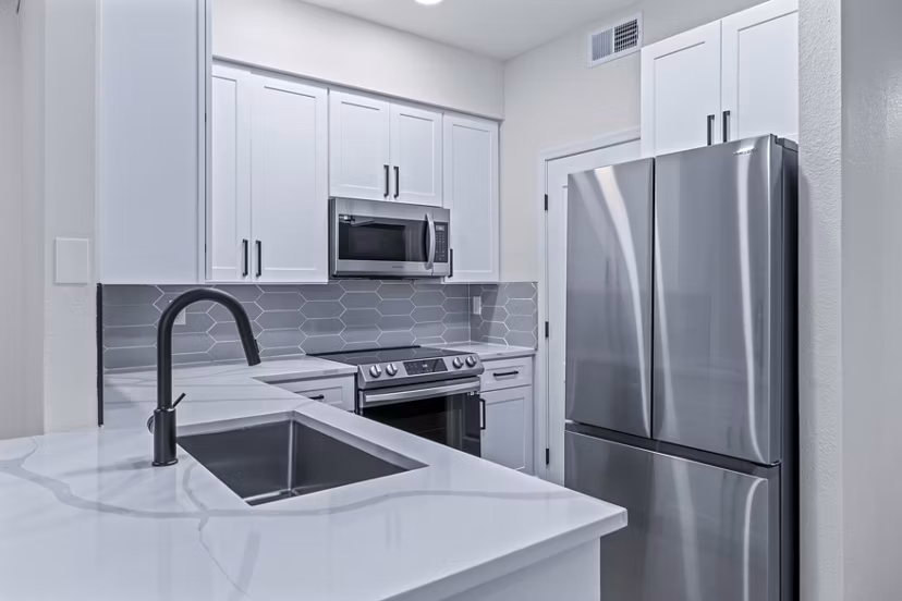Modern kitchen with stainless steel appliances and granite countertops at Haven at Midtown Apartments