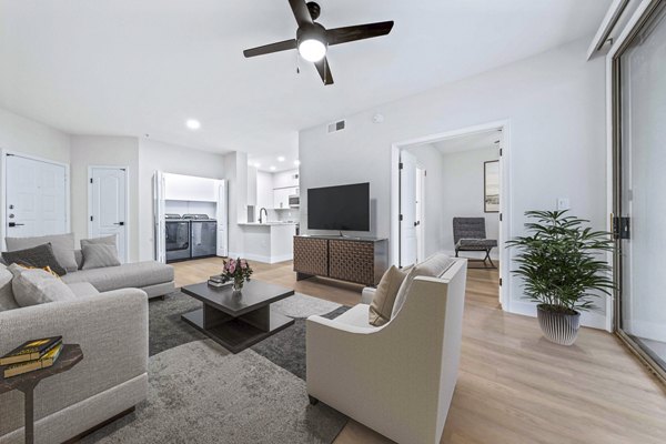 Spacious living room with modern decor and natural light in Haven at Midtown Apartments