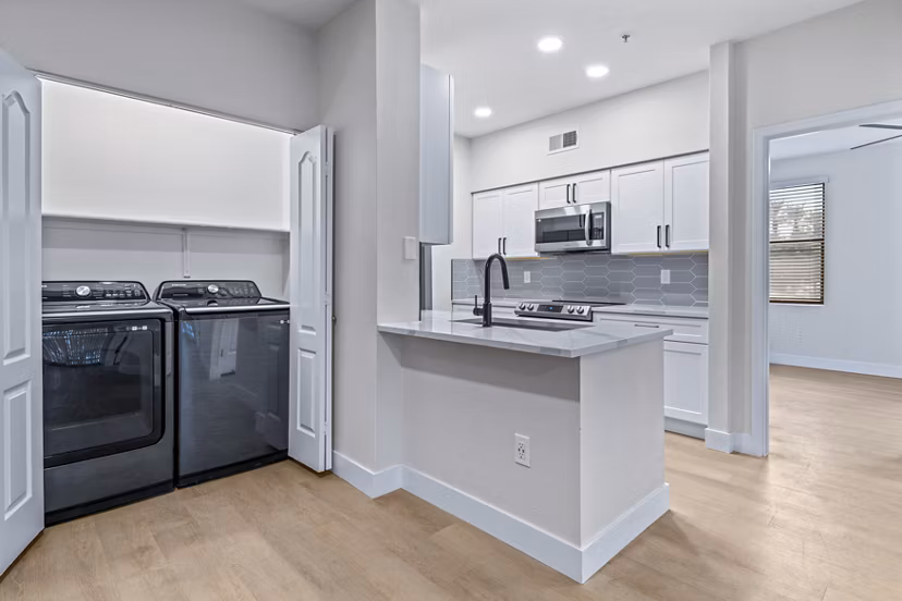 Modern laundry room featuring energy-efficient machines at Haven at Midtown Apartments