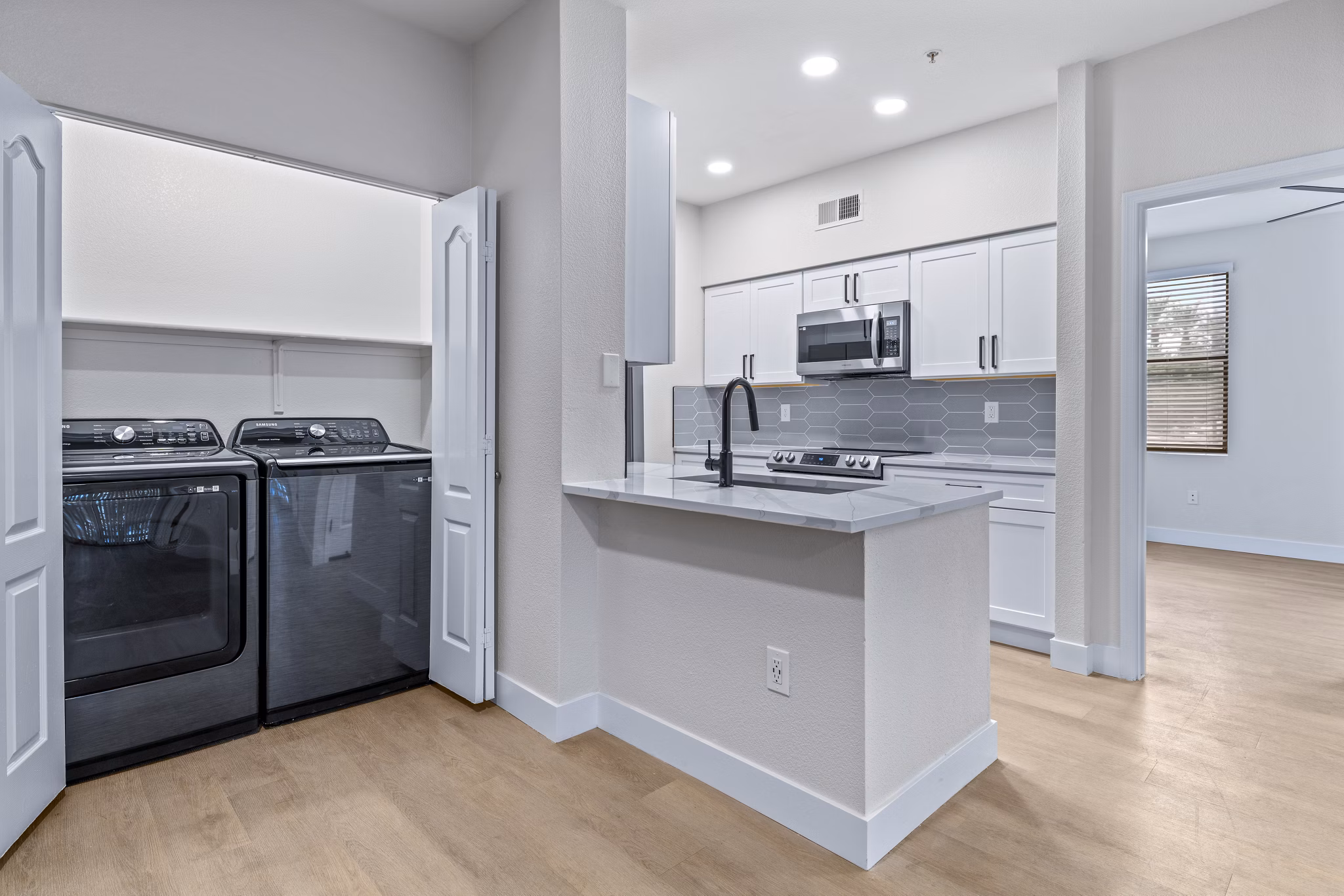 Modern laundry room featuring energy-efficient machines at Haven at Midtown Apartments