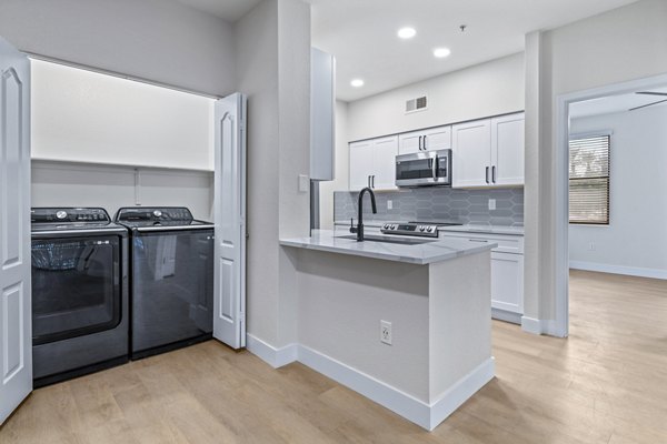 Modern laundry room featuring energy-efficient machines at Haven at Midtown Apartments