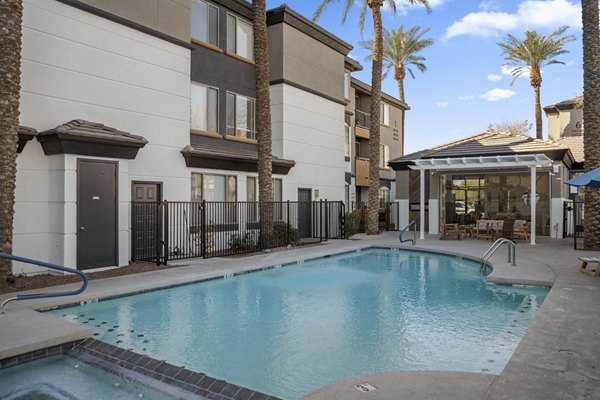 Resort-style pool with lounge chairs at Haven at Midtown Apartments, offering luxury living and amenities in a vibrant community setting