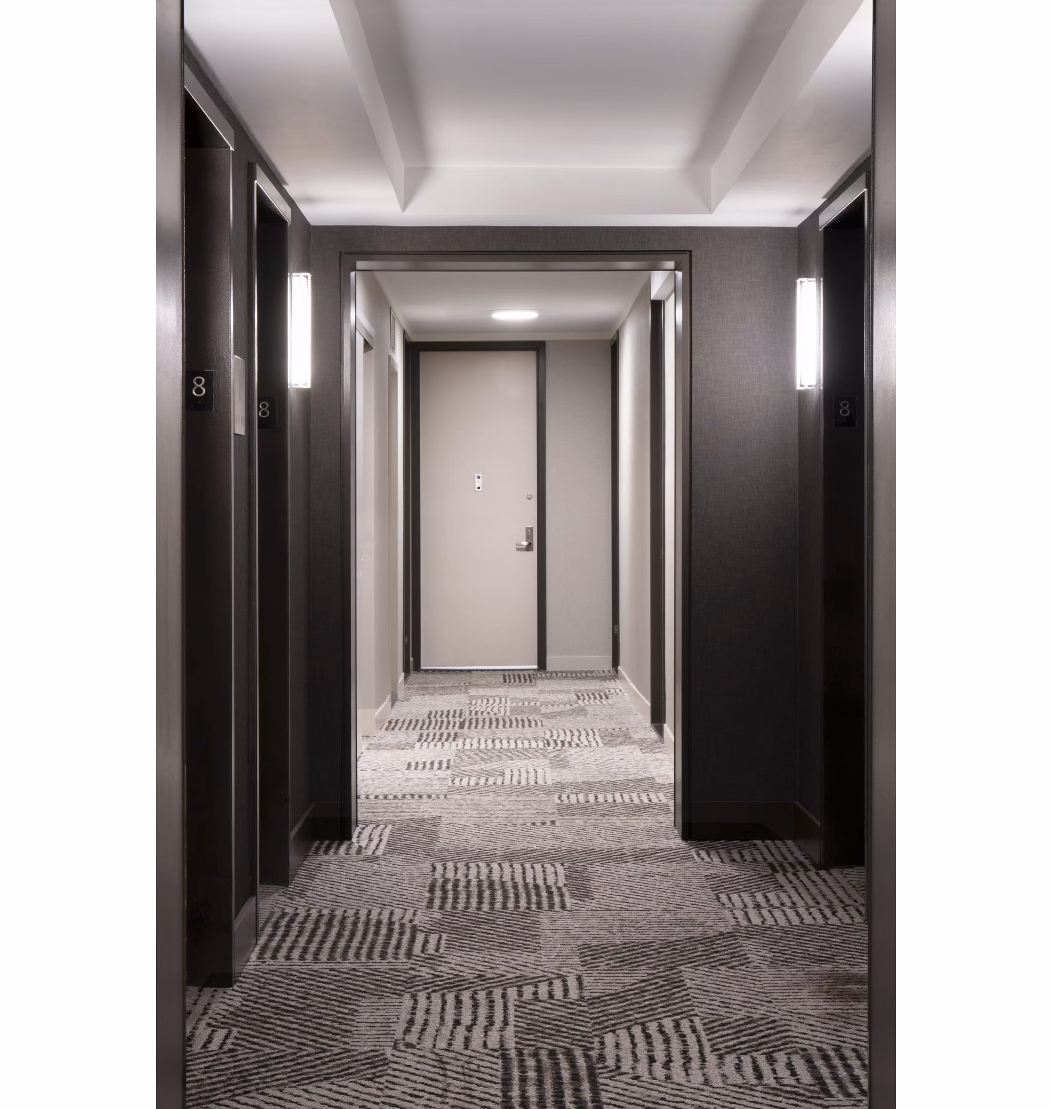 Hallway with modern lighting and elegant decor in Anagram NoMad Apartments