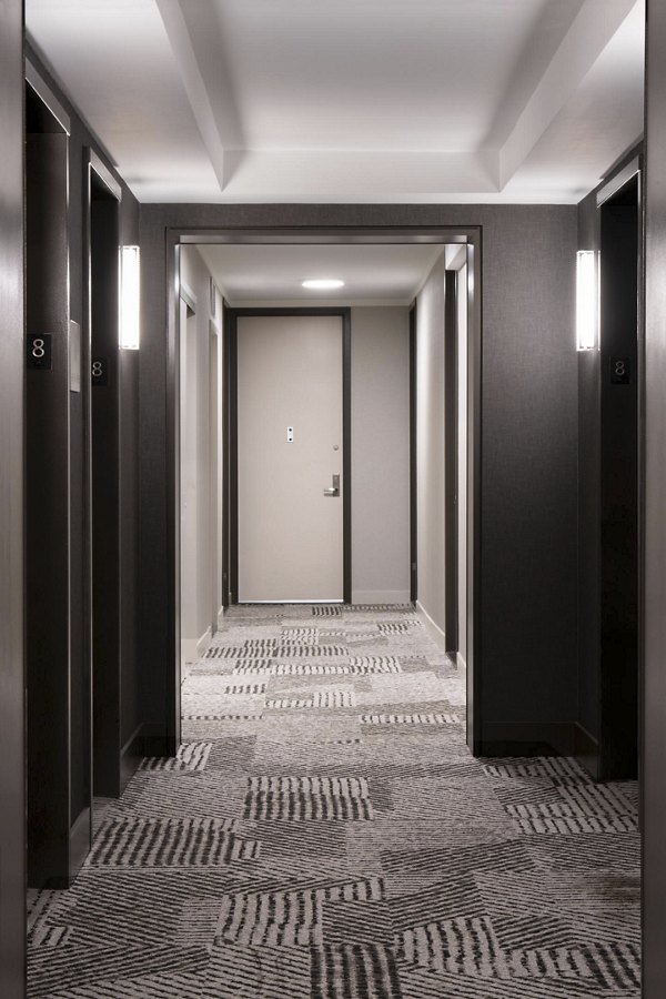 Hallway with modern lighting and elegant decor in Anagram NoMad Apartments