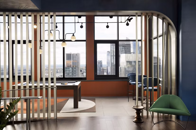 Modern clubhouse featuring seating areas and entertainment spaces at Anagram NoMad Apartments