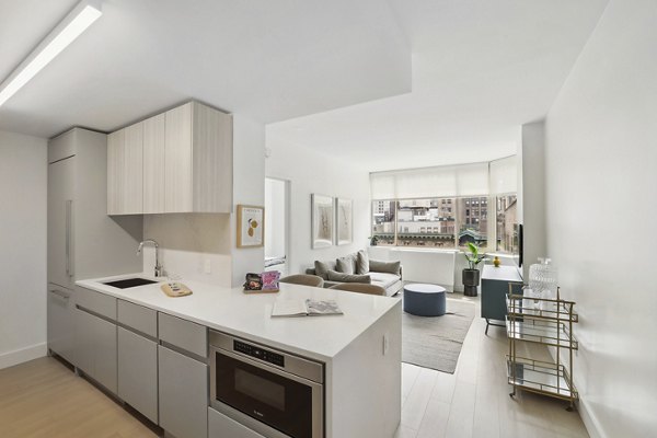 Modern kitchen with stainless steel appliances at luxury Anagram NoMad Apartments in New York City