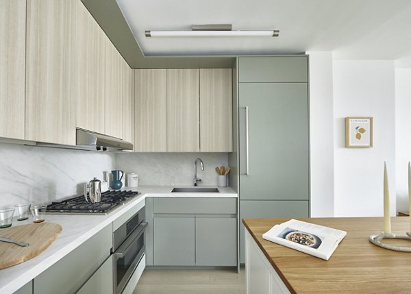 Modern kitchen with stainless steel appliances in Anagram NoMad Apartments