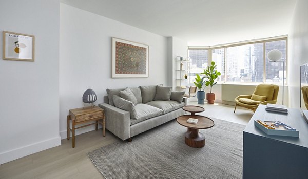 Modern living room with chic furnishings and abundant natural light at Anagram NoMad Apartments