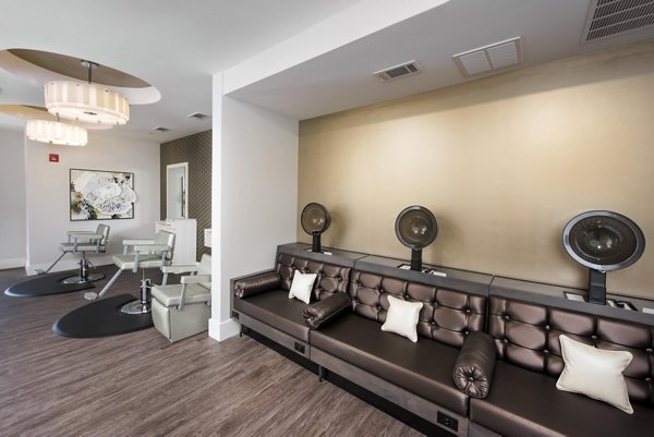 Elegant salon featuring luxurious furniture and a large mirror at Greystar's luxury apartments