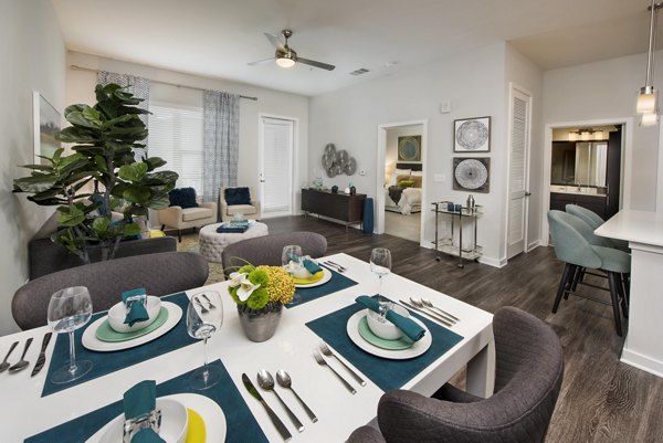 Dining room with elegant furnishings at Overture Barrett luxury apartments, featuring modern design and natural lighting