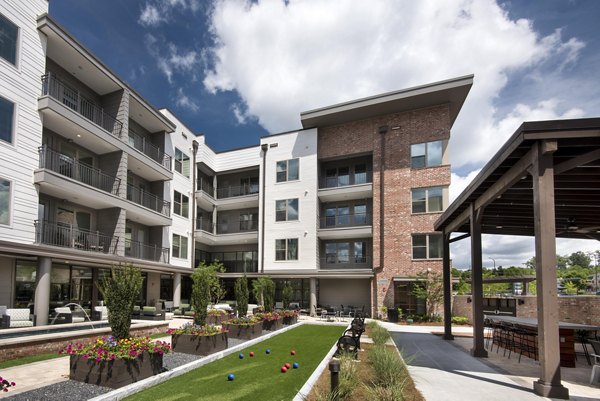 Patio area with stylish seating and garden view at Overture Barrett Apartments, ideal for relaxing and socializing in a luxurious setting