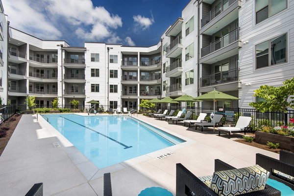 Luxurious pool with lounge chairs at Overture Barrett Apartments, ideal for relaxation and leisure