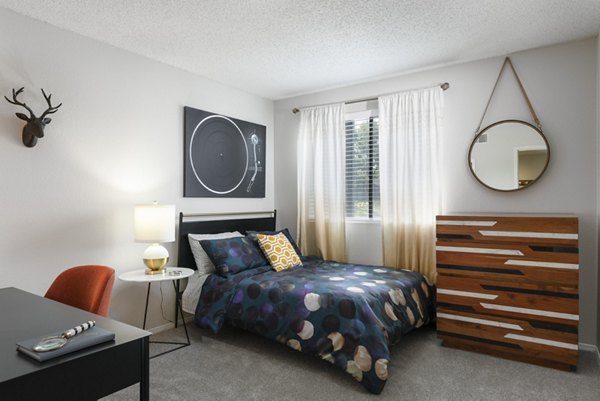 Bedroom featuring modern decor and large windows at Vista at Trappers Glen Apartments