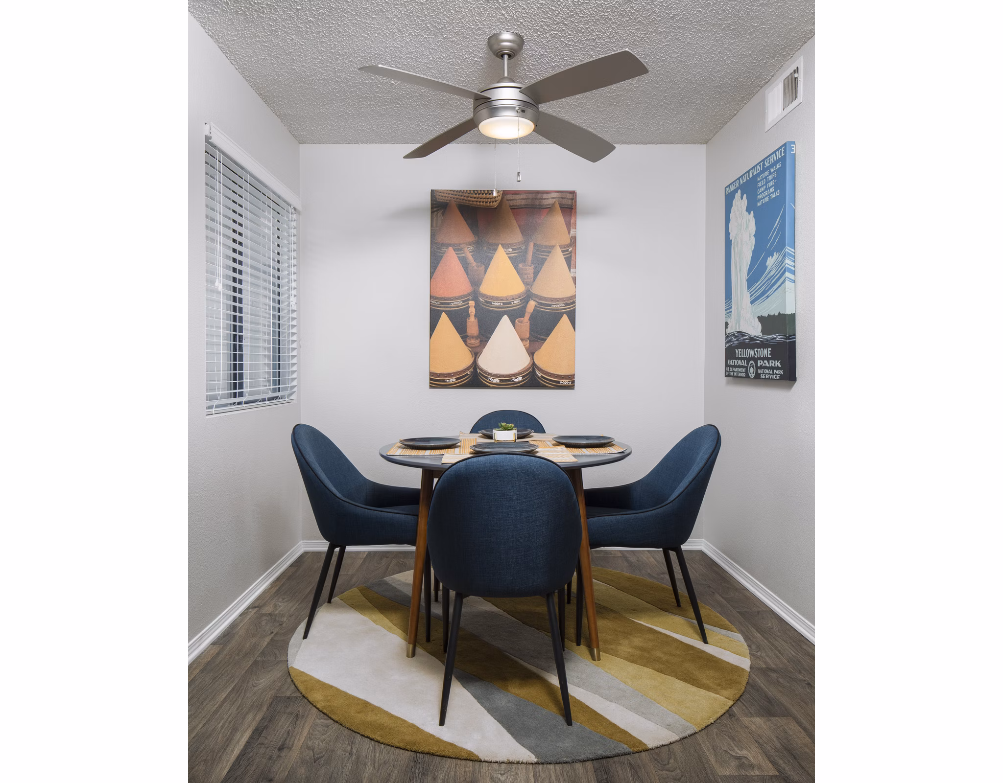 Dining room with elegant lighting and modern table setting at Vista at Trappers Glen Apartments