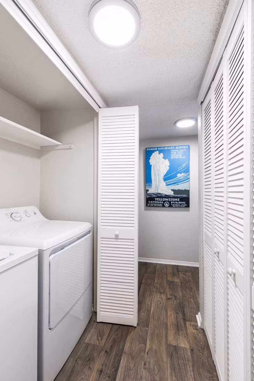 Laundry room featuring modern appliances at Vista at Trappers Glen Apartments
