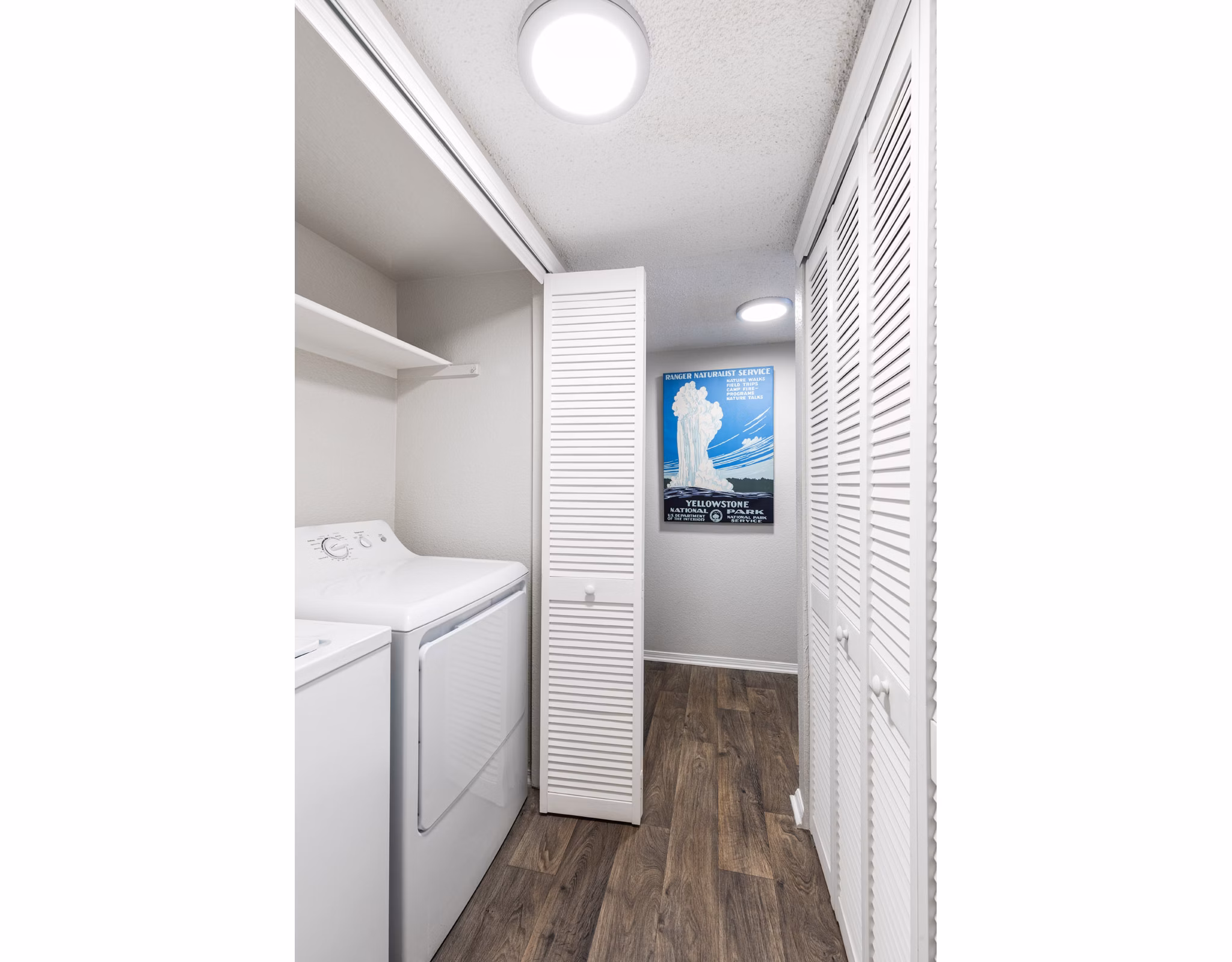 Laundry room featuring modern appliances at Vista at Trappers Glen Apartments