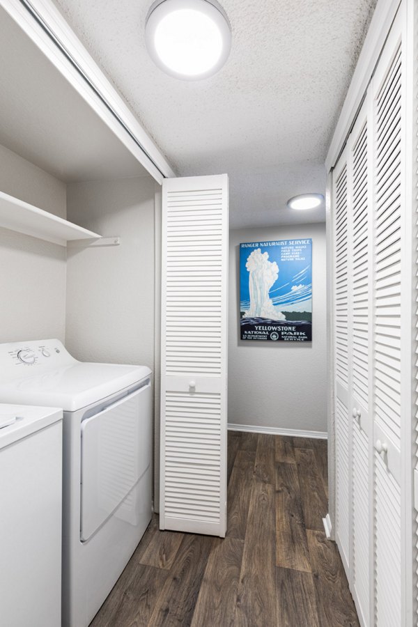 Laundry room featuring modern appliances at Vista at Trappers Glen Apartments