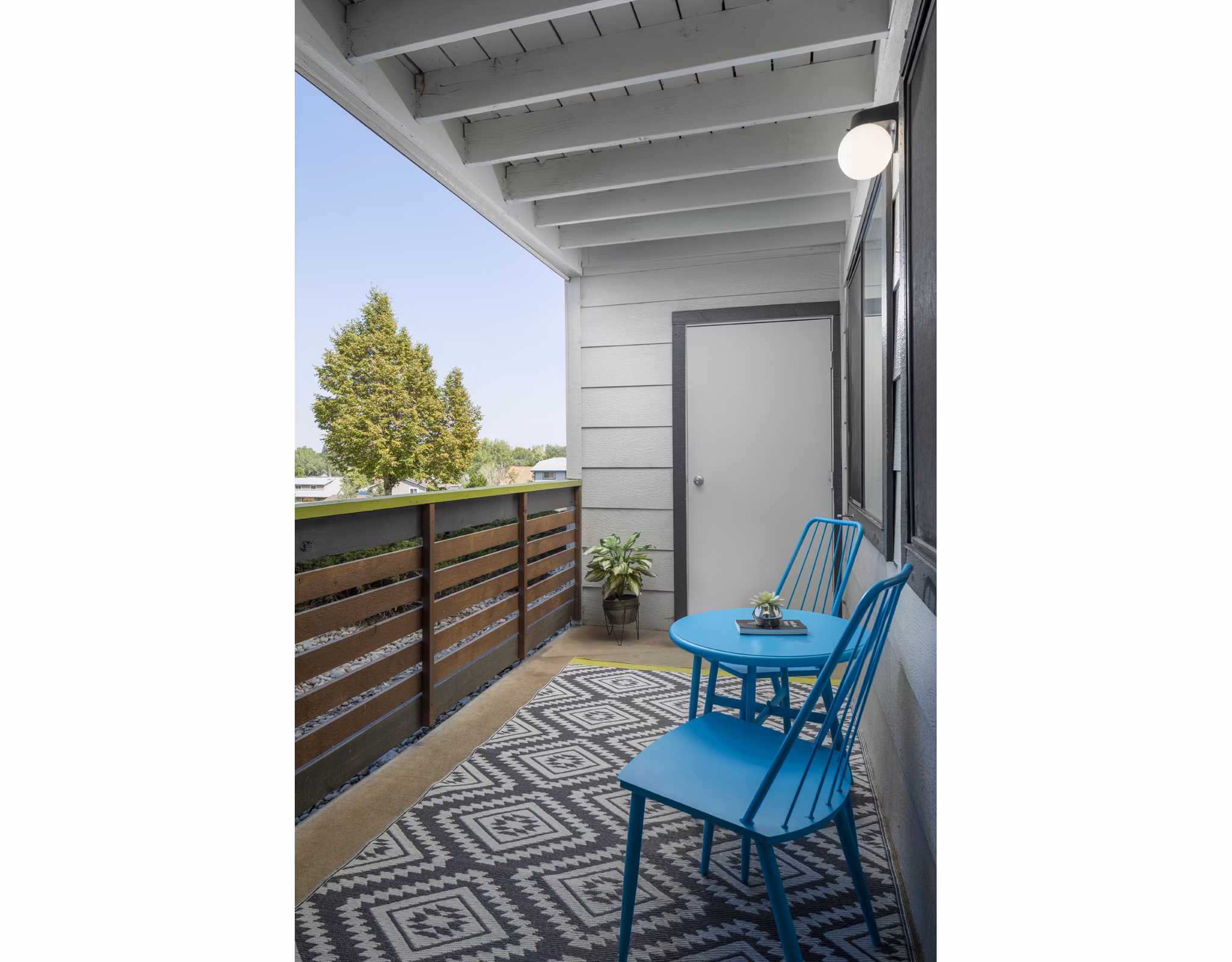 Patio with modern seating and fireplace at Vista at Trappers Glen Apartments