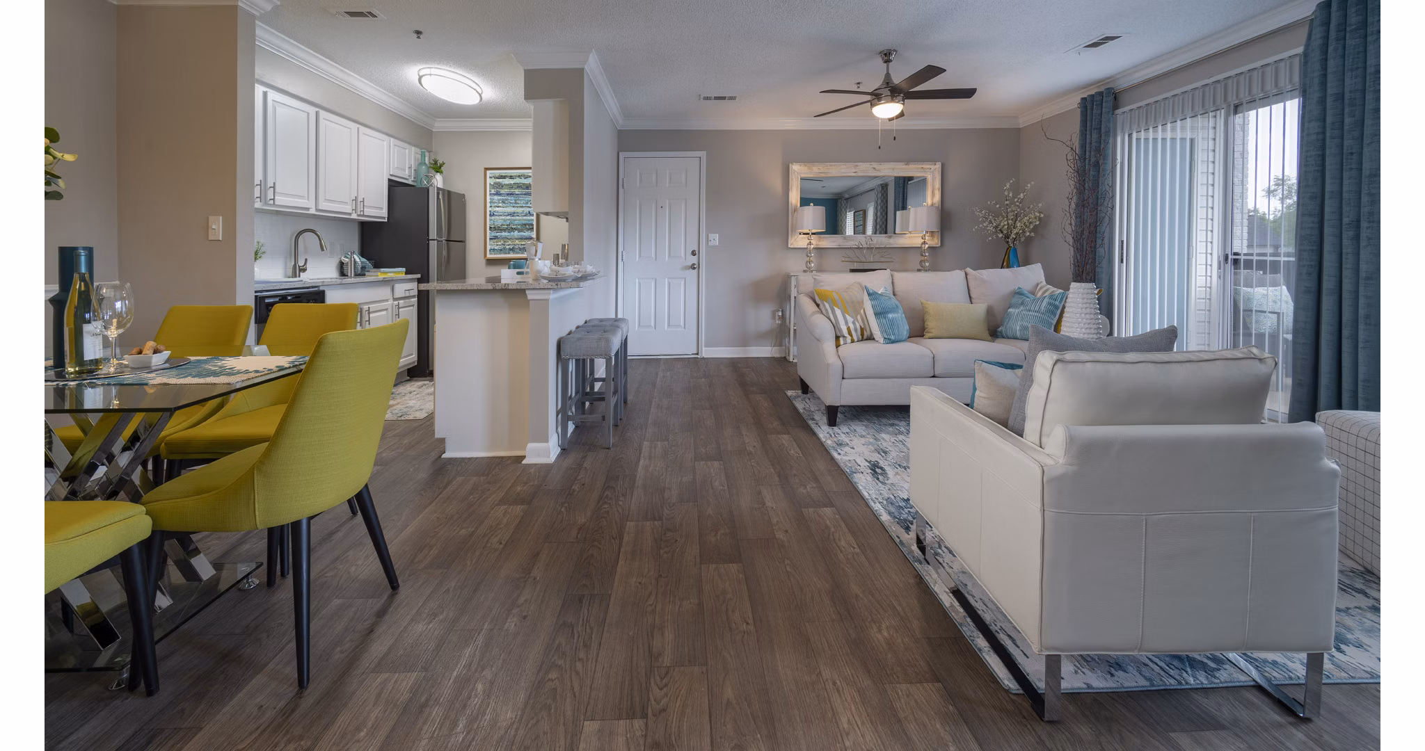 Spacious kitchen with granite countertops and stainless steel appliances in The Weathersby at Station Circle Apartments