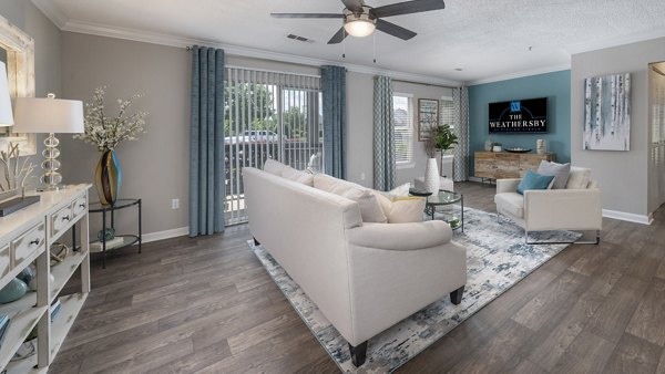 Spacious living room with modern decor in The Weathersby at Station Circle Apartments