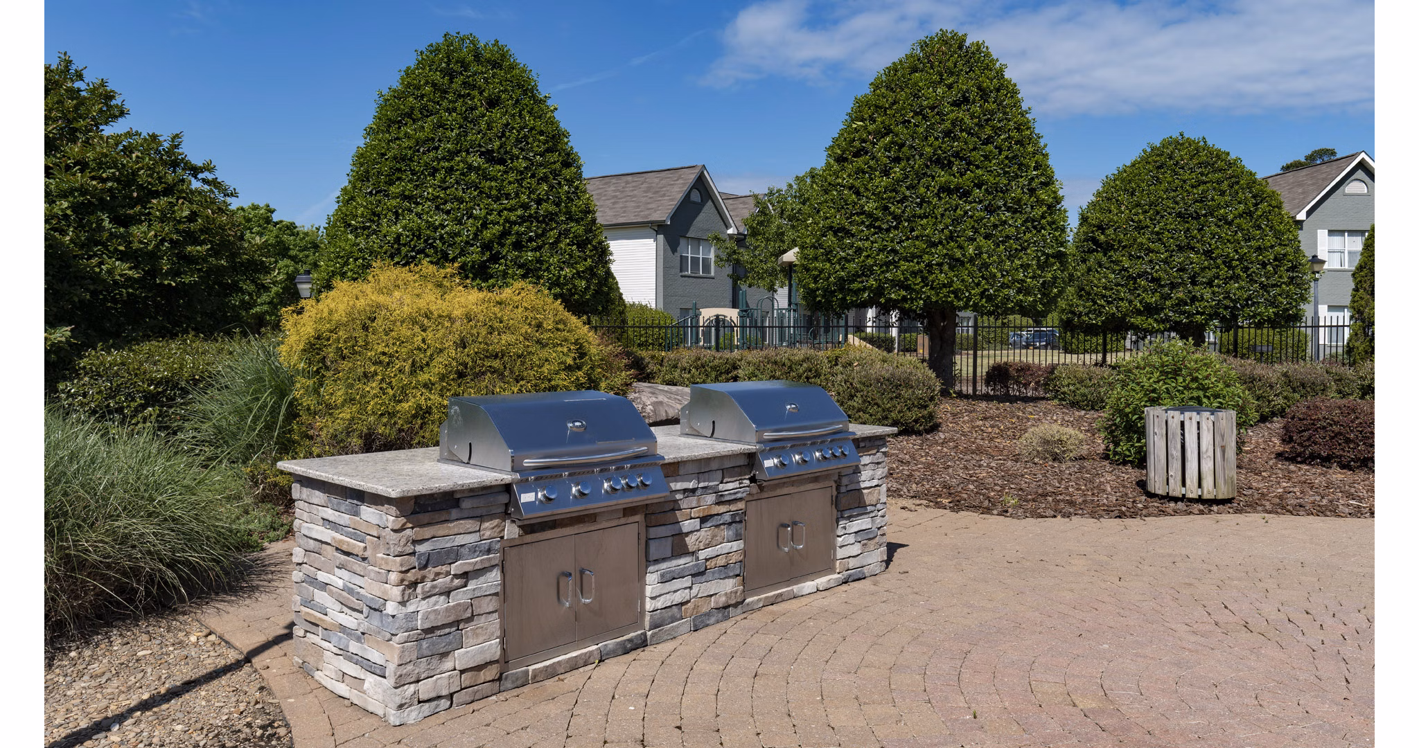 Outdoor grilling station with modern BBQ facilities at The Weathersby at Station Circle Apartments, perfect for social gatherings