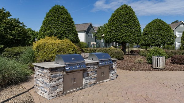 Outdoor grilling station with modern BBQ facilities at The Weathersby at Station Circle Apartments, perfect for social gatherings